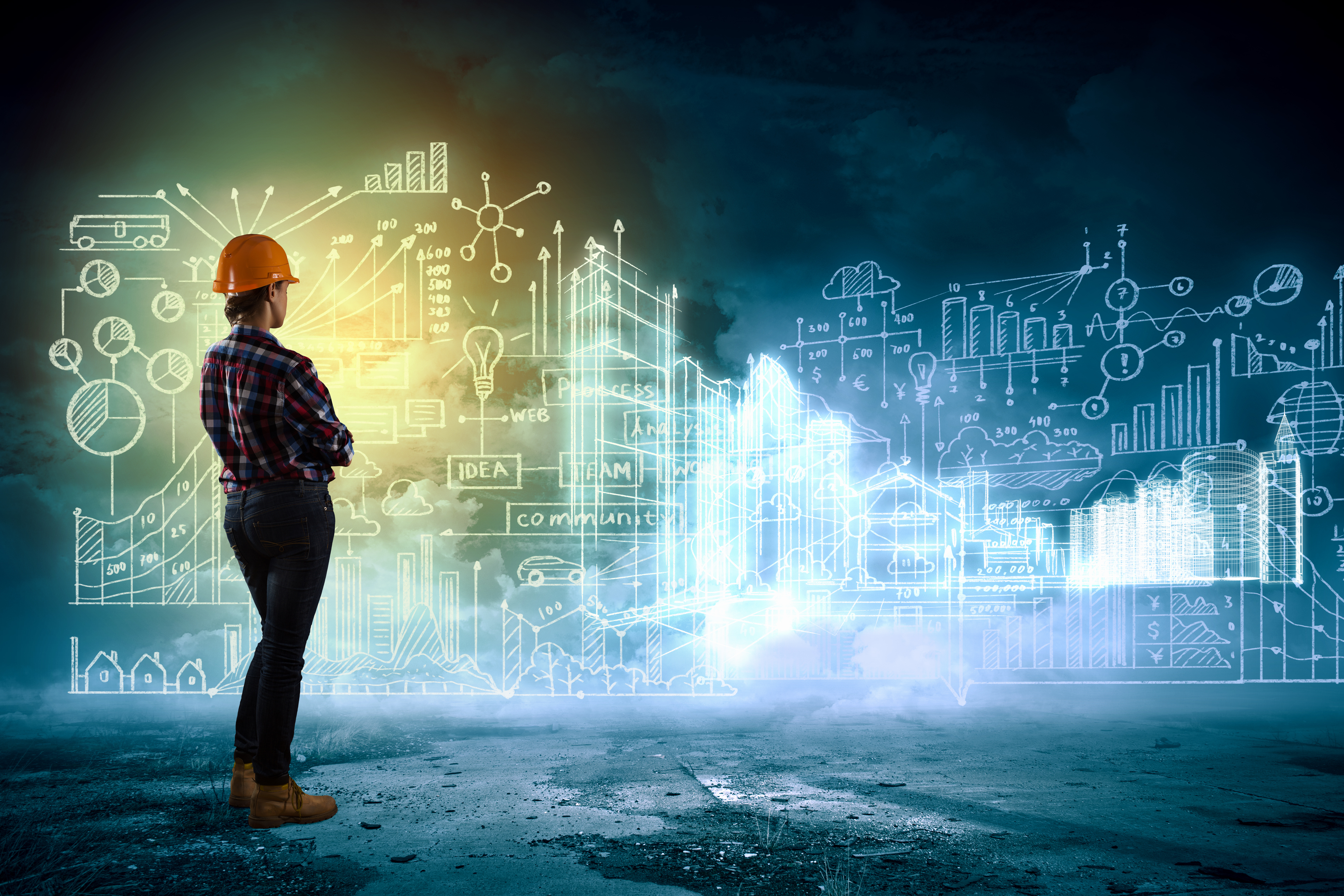 woman with hard hat looking at system diagram